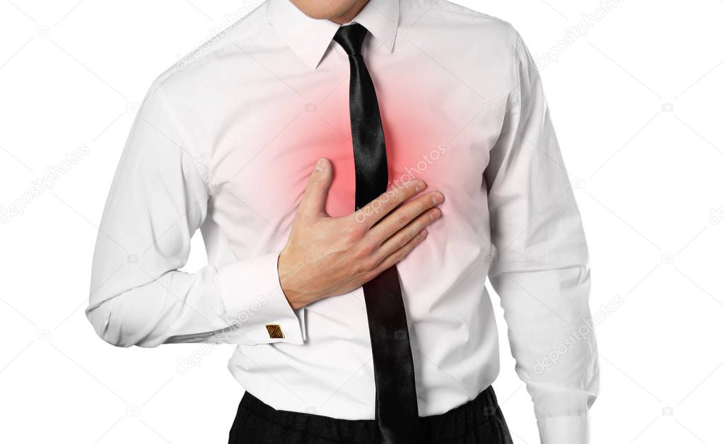 Businessman in a white shirt and tie holding his chest. Chest pain. Heartburn. Isolated on white background.