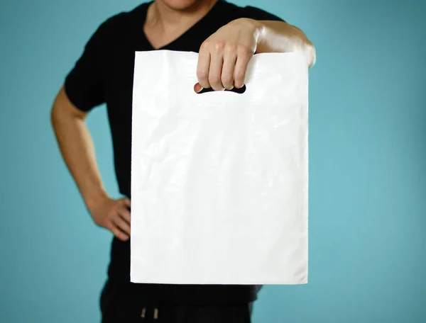 Man Holding White Plastic Bag Close Isolated Blue Background — Stock Photo, Image