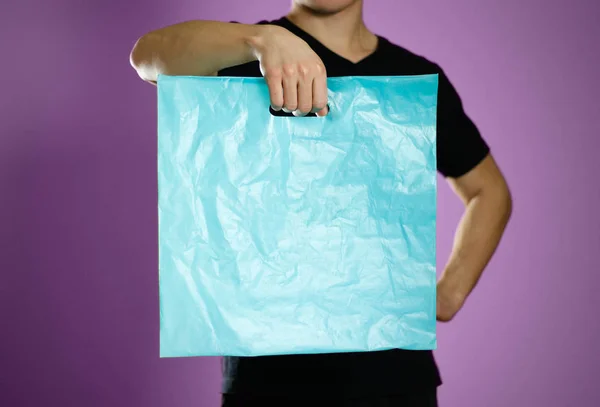 Man Holding Turquoise Plastic Bag Close Isolated Grey Background — Stock Photo, Image