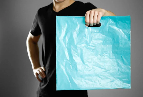 Man Holding Turquoise Plastic Bag Close Isolated Grey Background — Stock Photo, Image