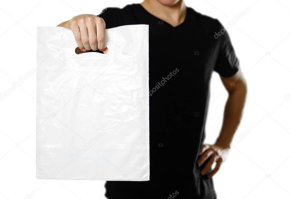 A man holding a white plastic bag. Close up. Isolated on white background.