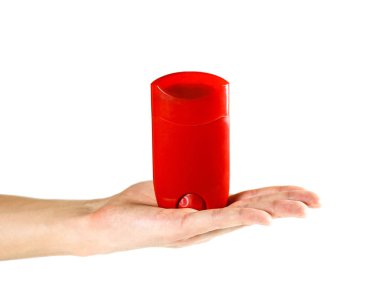 Hand holding a red antipersperant. Close up. Isolated on white background.