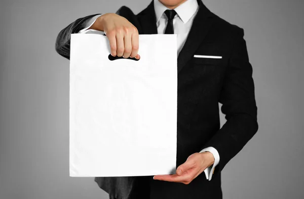 Businessman Black Suit Holding White Plastic Bag Close Isolated Background — Stock Photo, Image