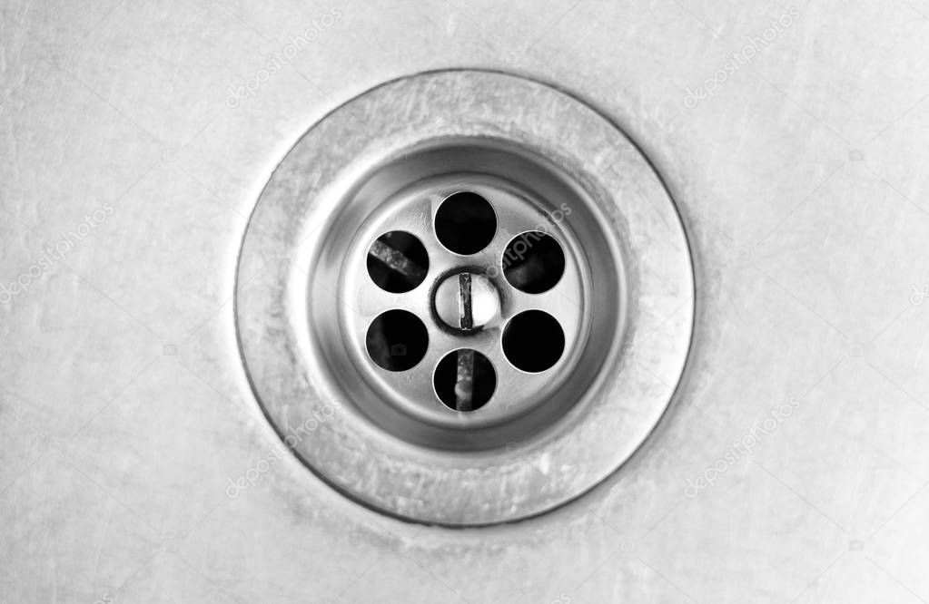 Drain hole in metal sink. Close up