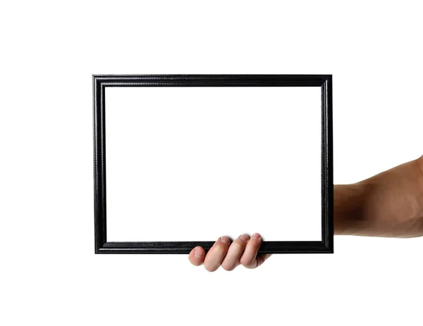 Mão segurando quadro A4 preto. Uma moldura vazia com um backgro branco — Fotografia de Stock