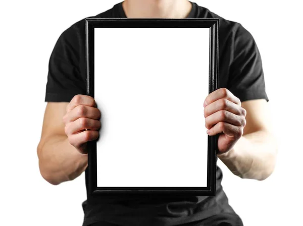 Ein Mann hält einen schwarzen a4-Rahmen. ein leerer Rahmen mit weißem Backgr — Stockfoto