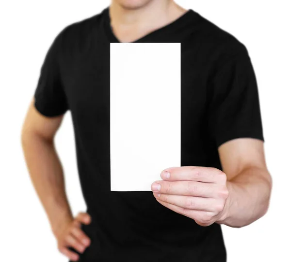 A man holding a white sheet of paper. Holding a booklet. Close u — Stock Photo, Image