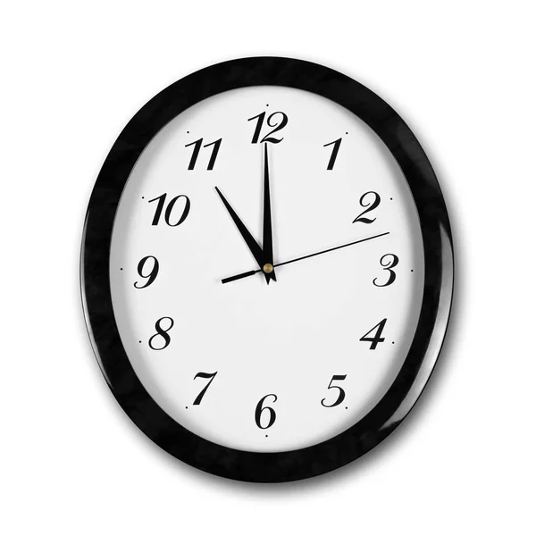 Large round white wall clock with black frame. The hands point t — Stock Photo, Image