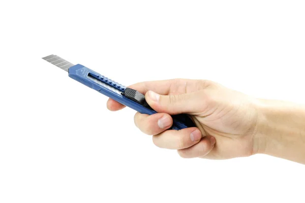 Hand holding a blue stationery knife. Close up. Isolated on whit — Stock Photo, Image