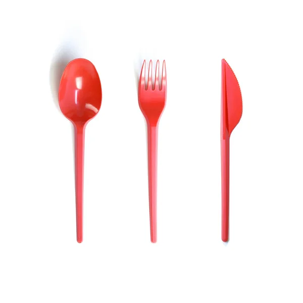 Plastic red disposable spoon, fork and knife. Close up. Isolated — Stock Photo, Image