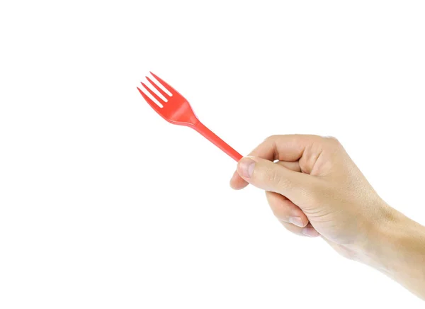 Mão segurando plástico garfo descartável vermelho. Fecha. Isolado em — Fotografia de Stock
