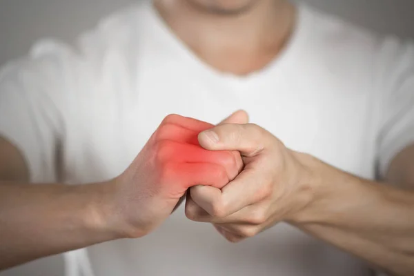 Pain Hand Man Highlighted Red Gray Background Close — Stock Photo, Image
