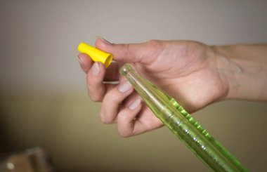 The hand changes the disposable hookah mouthpiece. Close up. clipart