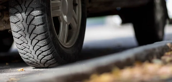 Wheel with winter studded tires. Close up. — Stock Image Wheel Winter Studded Tires Close Stock Picture