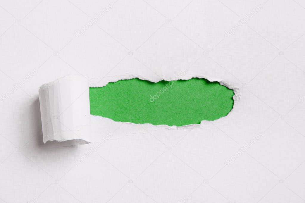 Torn white paper with green copy space for your text.