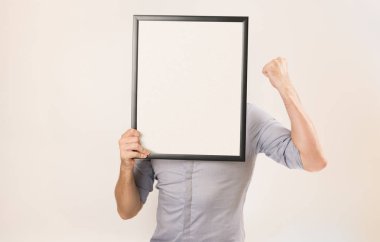 Bilinmeyen adam boş resim çerçeve i tutan iş gömlek giyiyor