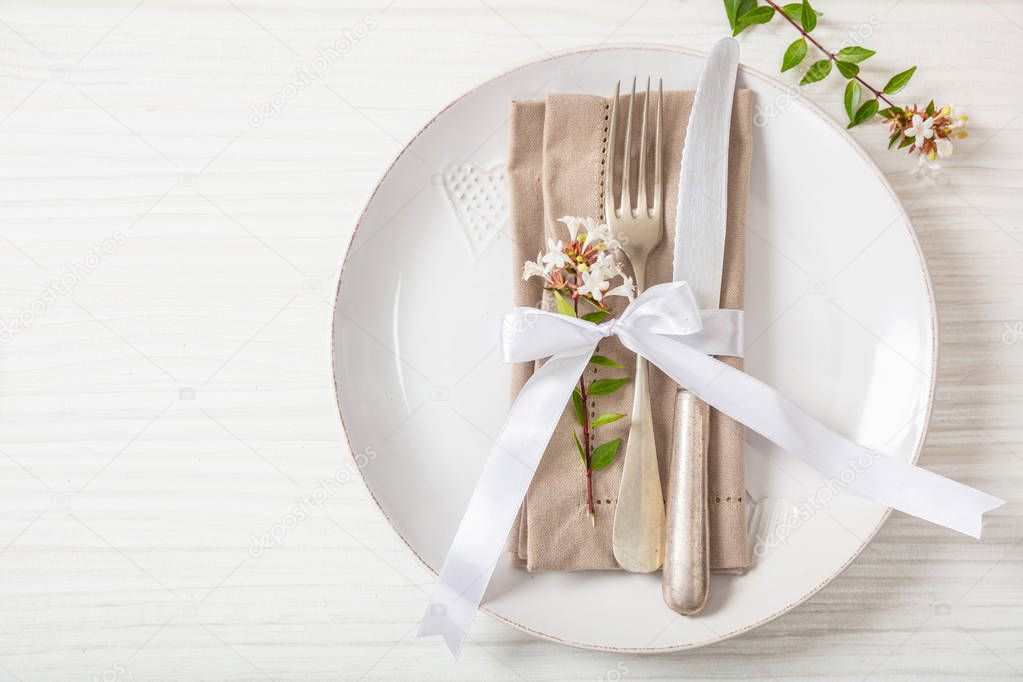 Holiday table place setting with plates, fork and knife, copy space