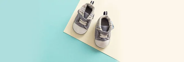 Baby boy shoes, shower invitation concept on pastel colors background, banner, copy space, top view