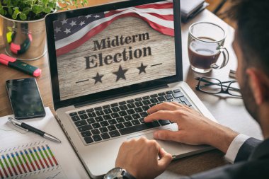 USA electronic vote concept. Businessman with a US of America midterm elections picture onscreen clipart