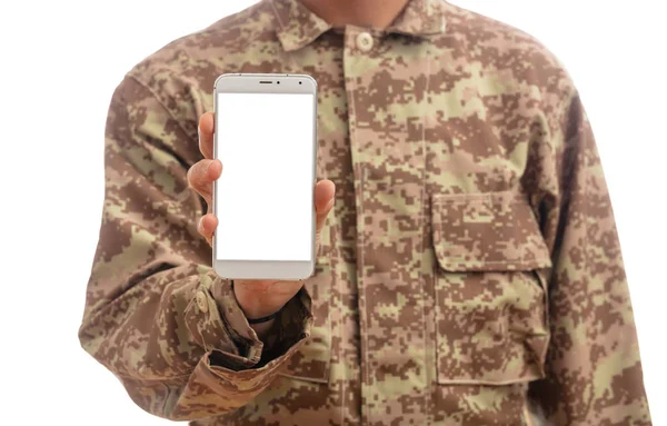 US Army. Young soldier showing a mobile phone with blank screen on white background