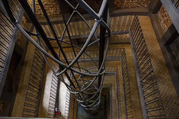 View of elevator shaft and staircase in the Astronomical Clock Tower in Prague, Czech Republic, gloomy,