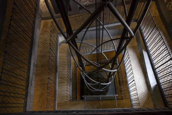 View of elevator shaft and staircase in the Astronomical Clock Tower in Prague, Czech Republic, gloomy,