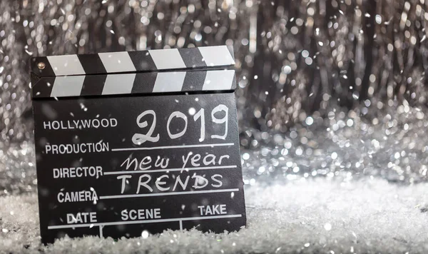 2019, new year trends on movie clapper, abstract bokeh lights background