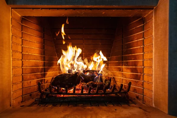 Christmas Time Cozy Fireplace Wood Logs Burning Red Firebricks Background — Stock Photo, Image