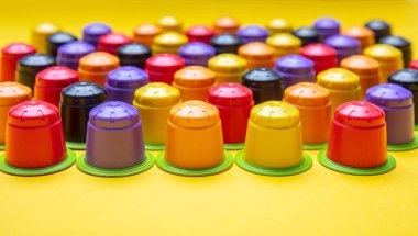 Coffee capsules compostable. Colorful espresso pods, eco friendly, aluminum free with green ring on yellow color background, banner