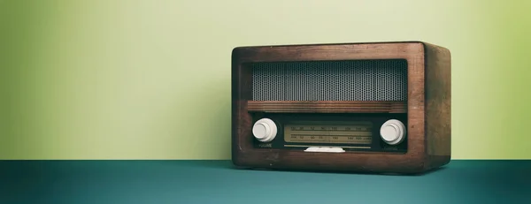 Vintage, retro radio. Radio old fashioned on green pastel wall background, banner. 3d illustration