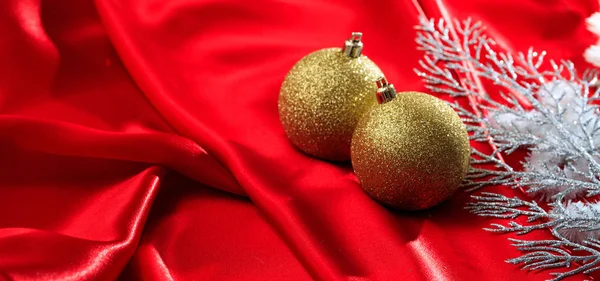 Christmas decoration. Christmas balls on red satin  background, banner — Stock Photo, Image