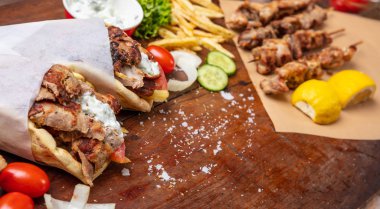 Gyro pide, shawarma, souvlaki. İki pide ekmek tamamladı ve et şiş ahşap tablo