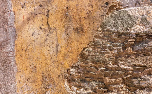 Old, distressed stone wall, building facade. Painted and faded, orange color masonry, texture background — Stock Photo, Image