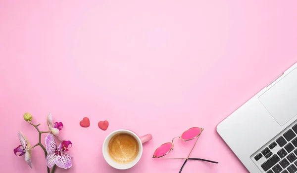 Kwiaty, filiżankę kawy i laptop na tle różowy biurko, kopiować miejsca — Zdjęcie stockowe