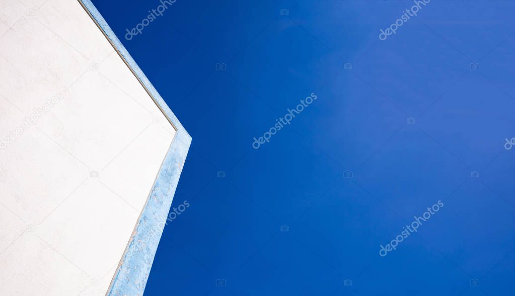 Greece. White building with blue details closeup view, blue sky background, copy space