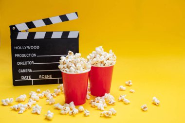 Sarı renk arka plan üzerinde Clapperboard ve pop mısır
