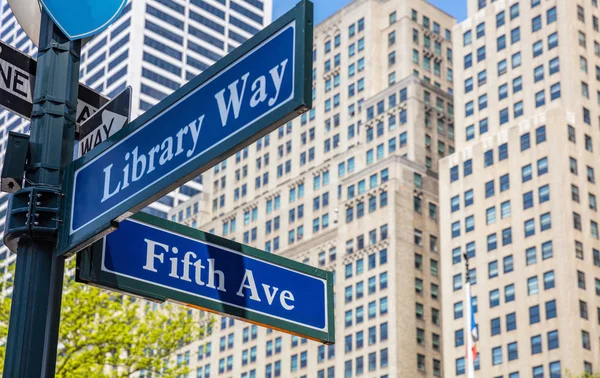 stock image 5th ave and Library Way corner. Blue color street signs, Manhattan New York downtown