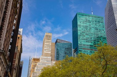 New York, Manhattan. Yüksek binalar mavi gökyüzü arka plan, ilkbaharda güneşli bir gün karşı aşağıdan görünümü