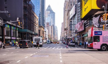 New York, sokaklar. Yüksek binalar, renkli neon ışıklar, arabalar ve insanlar