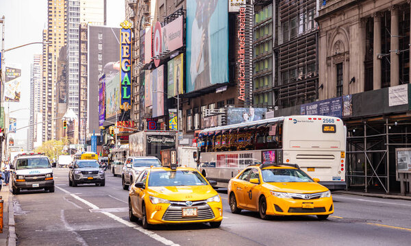 USA, New York, Manhattan streets. May 2, 2019. Skyscrapers, colorful neon signs and ads, cars and taxi cabs