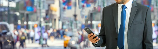 Nova Iorque, Wall Street. Jovem de terno segurando um smartphone — Fotografia de Stock