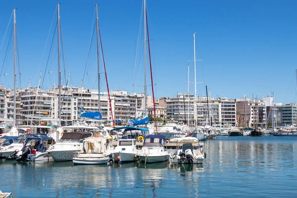 Marina Zeas in Piraeus, Greece. Many white moored yachts. Reflection of boats, blue calm sea, city and sky background. — Stock Photo, Image