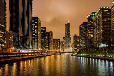 Chicago şehir akşam binaları aydınlatTı. Nehir kanalı üzerine yansımaları