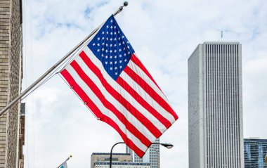 Chicago, Illinois şehir merkezinde Amerikan bayrağı. Highrise binalar ve bulutlu gökyüzü arka plan.
