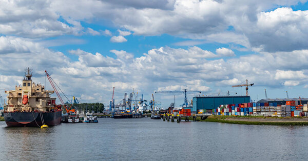 Cranes at harbor of Rotterdam, Netherlands. Logistics business, cargo loading unloading