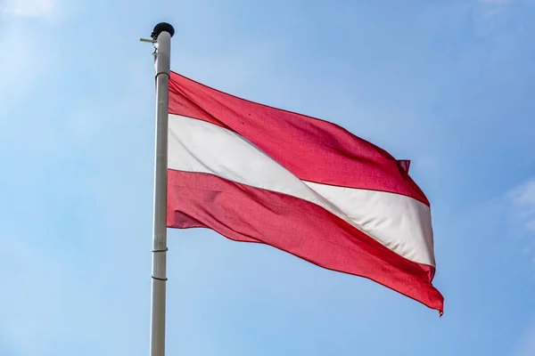 Austrian flag waving against clear blue sky