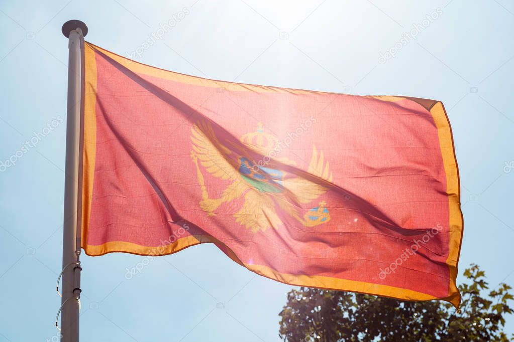 Montenegro flag waving against clear blue sky