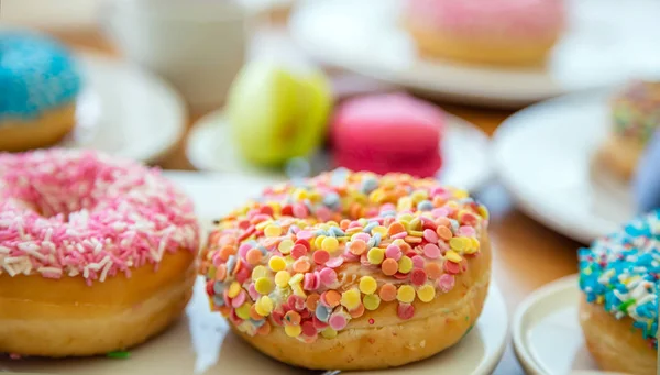 Donuts e macarons em madeira, vista de perto com detalhes — Fotografia de Stock