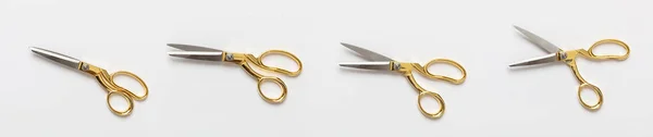 Ножиці золоті та срібні ізольовані на білому тлі — стокове фото