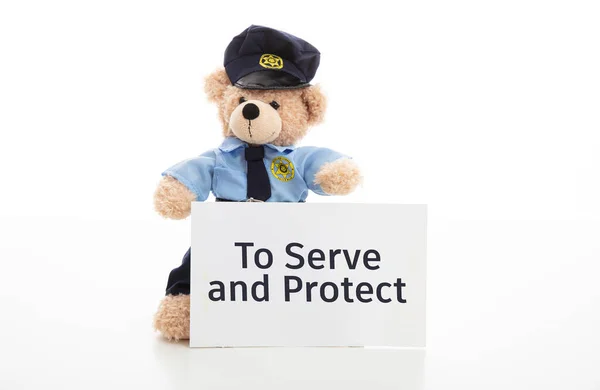 Cute teddy in policeman uniform, to serve and protect text on a paper isolated against white background